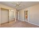 Standard bedroom featuring neutral paint, carpet, ceiling fan, and a mirrored closet at 1201 Bourbon St, Pahrump, NV 89048