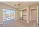 Bright bedroom featuring a sliding glass door, mirrored closet, and neutral carpet at 1201 Bourbon St, Pahrump, NV 89048
