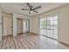 Bright bedroom with ceiling fan, closet with mirror doors and balcony access through sliding glass doors at 1201 Bourbon St, Pahrump, NV 89048