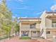 Multi-unit home back exterior featuring a balcony, patio, and Spanish-style roof at 1201 Bourbon St, Pahrump, NV 89048