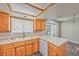 Charming kitchen featuring tile countertops, wooden cabinetry, and a breakfast bar area at 1201 Bourbon St, Pahrump, NV 89048