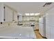 Well-lit kitchen features white cabinets, countertops, and appliances at 1201 Bourbon St, Pahrump, NV 89048