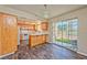 Traditional kitchen with wooden cabinets, white appliances, and a sliding glass door to the backyard at 1201 Bourbon St, Pahrump, NV 89048