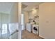 Laundry room features a washer, dryer, cabinets for storage, and a window at 1201 Bourbon St, Pahrump, NV 89048