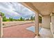 Covered patio providing shade and featuring low maintenance landscaping with a view of the walking path at 1201 Bourbon St, Pahrump, NV 89048