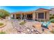 Spacious backyard with covered patio, water feature, and meticulous rock landscaping at 1641 Rockcrest Hills Ave, Henderson, NV 89052