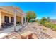 Well-maintained backyard boasts a covered patio, water feature, and lush plantings at 1641 Rockcrest Hills Ave, Henderson, NV 89052