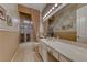 Elegant bathroom with long vanity, large mirror, and a glass-enclosed shower at 1641 Rockcrest Hills Ave, Henderson, NV 89052
