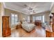 Cozy bedroom featuring shuttered windows, a ceiling fan, and classic furniture at 1641 Rockcrest Hills Ave, Henderson, NV 89052