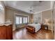 Inviting bedroom with hardwood floors, shuttered windows, and a comfortable seating area at 1641 Rockcrest Hills Ave, Henderson, NV 89052