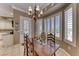 Inviting dining area with wood table, chandelier, and natural light from shuttered windows at 1641 Rockcrest Hills Ave, Henderson, NV 89052