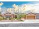 Inviting single-story home with a three-car garage and desert landscaping under a blue sky at 1641 Rockcrest Hills Ave, Henderson, NV 89052