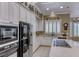 Modern kitchen boasts stainless steel appliances, sleek countertops, and ample white cabinetry at 1641 Rockcrest Hills Ave, Henderson, NV 89052