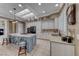 A well-lit kitchen features a sky light, an island with a cooktop, and modern appliances at 1641 Rockcrest Hills Ave, Henderson, NV 89052