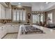 A gourmet kitchen with stainless steel appliances, white cabinets, and a quartz countertop island at 1641 Rockcrest Hills Ave, Henderson, NV 89052