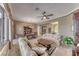 Open concept living and dining area with large windows, neutral tones and classic furnishings at 1641 Rockcrest Hills Ave, Henderson, NV 89052