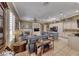 Bright and airy living space with fireplace, ceiling fan, and adjoining kitchen at 1641 Rockcrest Hills Ave, Henderson, NV 89052