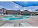 Inviting community pool featuring multiple water features, adjacent building and a bright blue sky at 1641 Rockcrest Hills Ave, Henderson, NV 89052