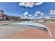 Beautiful community pool with multiple chairs, umbrellas and an adjacent building in a sunny day at 1641 Rockcrest Hills Ave, Henderson, NV 89052