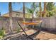 Relaxing backyard nook with a hammock, patio pavers, and ambient string lights for tranquil outdoor living at 1717 Jake Andrew Ave, North Las Vegas, NV 89086