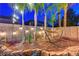 Charming backyard with string lights, a hammock, and mature trees, creating a cozy outdoor oasis at 1717 Jake Andrew Ave, North Las Vegas, NV 89086