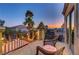 Cozy balcony with comfortable seating and string lights, perfect for enjoying beautiful sunset views at 1717 Jake Andrew Ave, North Las Vegas, NV 89086