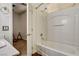 Bright bathroom showcasing a tub-shower combo with white tile surround and updated chrome fixtures at 1717 Jake Andrew Ave, North Las Vegas, NV 89086