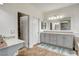 Bathroom featuring double sinks, linen closet, and tile flooring at 1717 Jake Andrew Ave, North Las Vegas, NV 89086