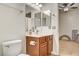 Functional bathroom featuring a wood vanity, a sink with vanity lights, and ceramic tile floors at 1717 Jake Andrew Ave, North Las Vegas, NV 89086