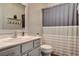 Cozy bathroom features a large mirror, vanity with great storage, and a shower with decorative curtains at 1717 Jake Andrew Ave, North Las Vegas, NV 89086