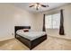 Comfortable bedroom with a ceiling fan, large window, and a stylish platform bed at 1717 Jake Andrew Ave, North Las Vegas, NV 89086