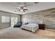 Bedroom featuring a wood accent wall, a ceiling fan, and sliding glass door to balcony at 1717 Jake Andrew Ave, North Las Vegas, NV 89086