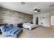 Bedroom featuring an accent wall, chaise lounge, and ensuite bath at 1717 Jake Andrew Ave, North Las Vegas, NV 89086