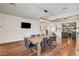 Spacious dining room featuring wooden floors, statement wall paneling, and beverage station at 1717 Jake Andrew Ave, North Las Vegas, NV 89086