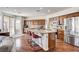 Well-equipped kitchen with wood cabinets, stainless appliances, granite counters, and island with bar seating at 1717 Jake Andrew Ave, North Las Vegas, NV 89086