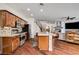 Bright kitchen featuring wooden cabinetry, stainless steel appliances, and a center island with seating at 1717 Jake Andrew Ave, North Las Vegas, NV 89086