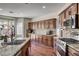 Gourmet kitchen featuring granite countertops, stainless steel appliances, and wood cabinets at 1717 Jake Andrew Ave, North Las Vegas, NV 89086