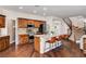 Open kitchen featuring wood cabinets, stainless steel appliances, granite countertops, and a large center island with seating at 1717 Jake Andrew Ave, North Las Vegas, NV 89086