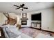 Spacious living room with a fireplace, tv, staircase, and comfortable seating area at 1717 Jake Andrew Ave, North Las Vegas, NV 89086