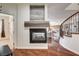 Inviting living room featuring a cozy fireplace, hardwood floors, and an open layout with seamless flow into the kitchen at 1717 Jake Andrew Ave, North Las Vegas, NV 89086