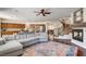 Spacious living room with hardwood floors, a fireplace, and a view of the kitchen and staircase at 1717 Jake Andrew Ave, North Las Vegas, NV 89086
