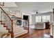 View of staircase and living room featuring a fireplace, TV, and a comfortable seating area at 1717 Jake Andrew Ave, North Las Vegas, NV 89086