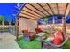 Comfortable outdoor living space with covered seating, and landscaped surroundings at 1717 Jake Andrew Ave, North Las Vegas, NV 89086