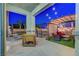 Covered patio with outdoor kitchen, seating area, and views of the sparkling pool, ideal for entertaining at 1717 Jake Andrew Ave, North Las Vegas, NV 89086