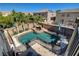Backyard pool area features a rock spa, lush landscaping, and a safety fence ensuring privacy and security at 1717 Jake Andrew Ave, North Las Vegas, NV 89086
