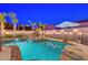 Inviting backyard pool features a rock waterfall feature and tropical landscaping at 1717 Jake Andrew Ave, North Las Vegas, NV 89086