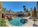 Beautiful pool with waterfall feature and mature landscaping, offering a relaxing outdoor space for entertaining at 1717 Jake Andrew Ave, North Las Vegas, NV 89086
