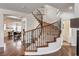 Sweeping staircase with wooden railing and iron spindles, connecting the different levels of this stylish home at 1717 Jake Andrew Ave, North Las Vegas, NV 89086