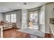 Sunroom with large windows, dark hardwood floors, and access to outdoor patio at 1717 Jake Andrew Ave, North Las Vegas, NV 89086