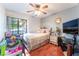 Comfortable bedroom features hardwood flooring, ceiling fan, and plenty of natural light at 1723 Candice St, Las Vegas, NV 89156